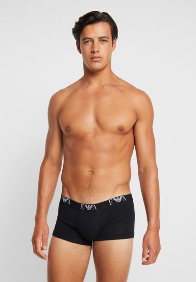 Boxeri negri, dintr-un material neted, cu un tiv contrastant și cu brand. Designul este potrivit, având o lungime scurtă a piciorului.