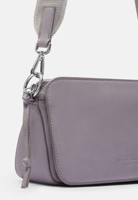 Purple leather crossbody bag with silver metal hardware and a textured strap. Features a rounded shape and subtle logo detailing.