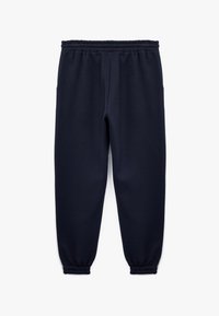 Marineblå sweatpants lavet af blødt materiale, med elastisk talje, sidelommer og elastiske manchetter ved anklerne.
