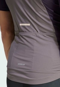 Gray athletic shirt with a fitted design, smooth texture, and a vertical white stripe detail near the back. Features "AEROREADY" branding.