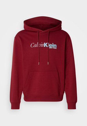 Bordeaux capuchon sweatshirt van fleece stof met een kangoeroezak, geribde manchetten en het "Calvin Klein NEW YORK" logo in wit en blauw.