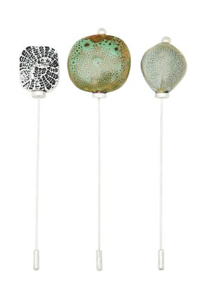 Three decorative hat pins with round, square, and oval glass heads. Features include speckled green, black geometric patterns, and silver-tone stems.