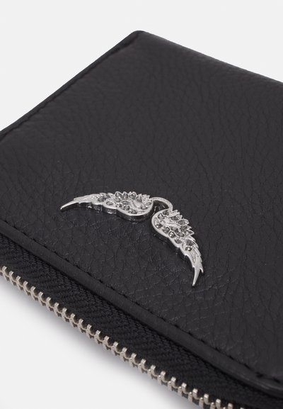 Black leather wallet with a textured surface, featuring a decorative silver wing accent and a zip closure at the edge.