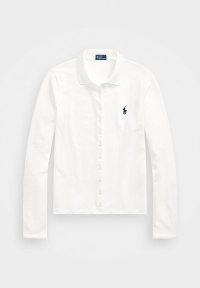 White long-sleeve polo shirt, featuring a button-down front, soft texture, and a small dark blue logo on the left chest.
