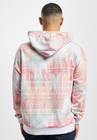 Hooded sweatshirt featuring a pastel color scheme with geometric patterns. Made of soft fabric with a relaxed fit and ribbed hem.