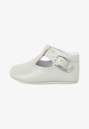Light gray leather baby shoe with a rounded toe, cut-out detail on the sides, and an adjustable strap with a metal buckle.