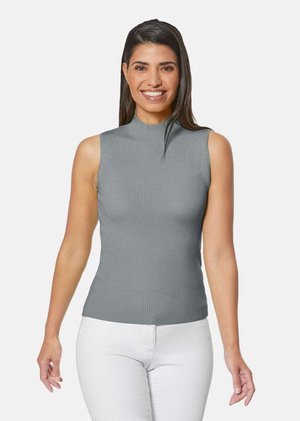 Grauer ärmelloser Oberteil mit hohem Kragen, aus geripptem Stoff. Das Design hat eine taillierte Silhouette und wird mit weißen Hosen kombiniert.