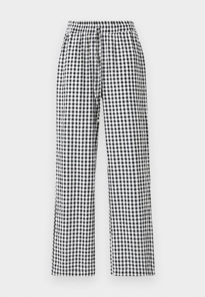 Pantalones de cuadros vichy en blanco y negro con un corte relajado, cinturilla elástica y detalle de cordón. La tela tiene una textura suave.