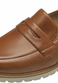 Mocassin en cuir marron avec un design à bout moc, détail de sangle décoratif et semelle en caoutchouc claire.