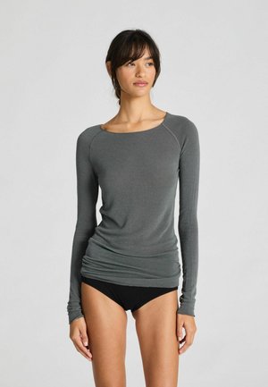 Long-sleeve, gray top with a scoop neckline and fitted design. Soft texture, gathered detail at the waist, and ribbed long sleeves.