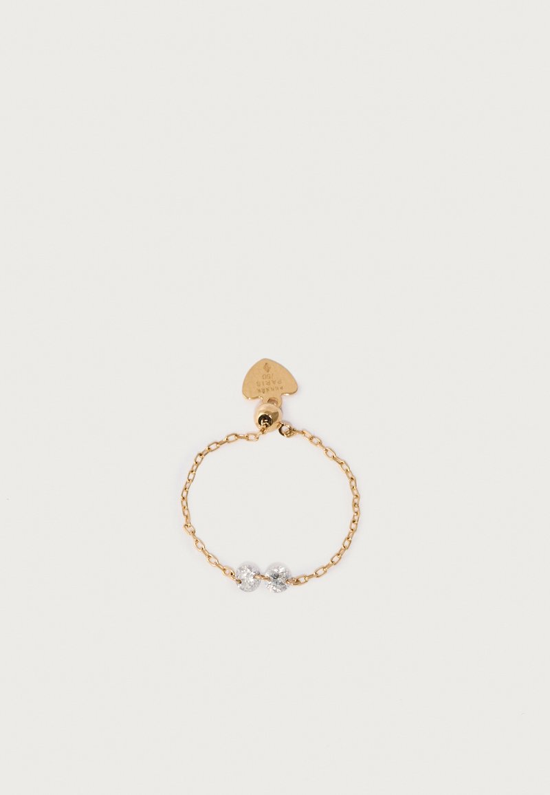 Gold chain bracelet featuring two clear round crystals at the center and a triangular tag attached. Smooth texture, delicate design.
