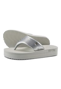 Silver flip-flop sandals with a textured strap, cushioned white sole, and wavy tread pattern. Brand logo visible on the side.