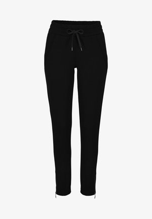 Schwarze Jogginghose mit elastischem Bund, Kordelzug, Seitentaschen und Reißverschlüssen an den Knöcheln. Aus weichem Material gefertigt.