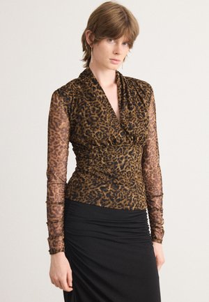 Brown leopard-print top with long sheer sleeves and a draped neckline, paired with a fitted black skirt. Smooth texture, form-fitting design.