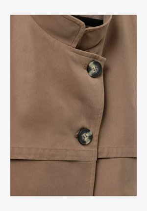 Brown cotton jacket featuring a mandarin collar, two large buttons, and a side pocket with a smooth texture and structured design.