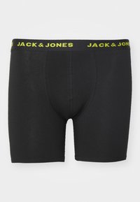 Schwarze Boxer Shorts mit enganliegendem Design. Der elastische Bund ist mit dem gelben "JACK & JONES"-Logo versehen. Glatte Stofftextur, ohne Muster.