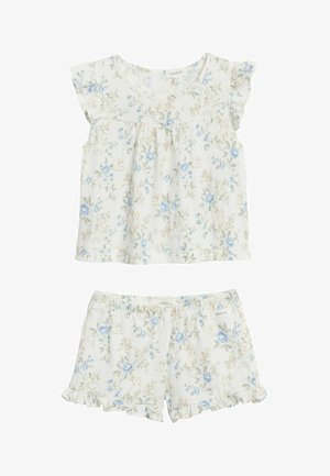 Tyttöjen valkoinen pyjamapuku vaaleansinisin kukka- ja pupukuvioin, jossa lyhythihainen yläosa ja röyhelöreunaiset shortsit.