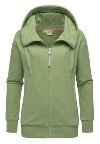 Felpa verde con zip realizzata in tessuto morbido. Presenta un grande cappuccio, due tasche frontali e polsini a costine. Cuciture decorative lungo il cappuccio.