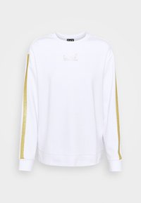 Felpa bianca con maniche lunghe, caratterizzata da strisce di glitter dorato lungo i lati e un piccolo logo luminoso sul petto. Tessuto morbido.
