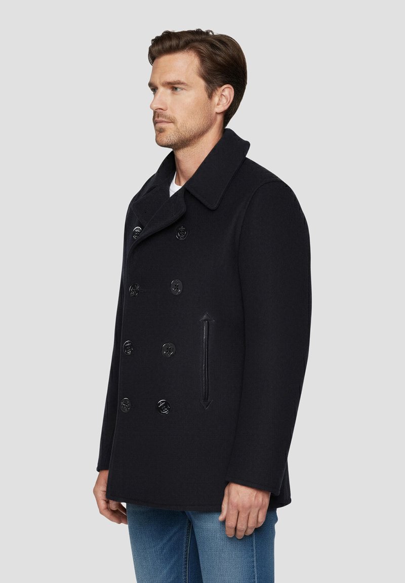 Manteau en laine noire de style caban avec un design croisé, grand col et boutons brillants. Comprend une poche latérale et une coupe décontractée.