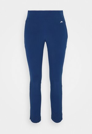 Blaue enganliegende Sporthose mit hohem Bund und kleinem weißen Logo auf der oberen linken Hüfte, auf weißem Hintergrund präsentiert.