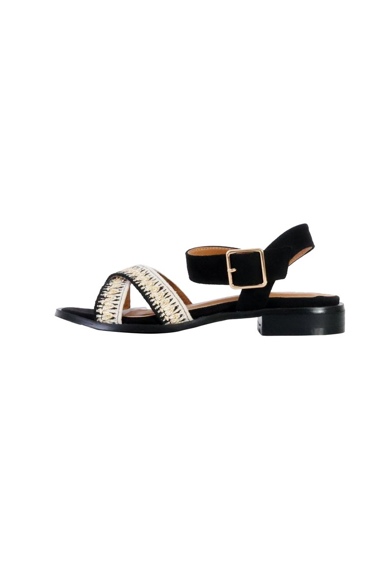 Black suede sandal with a low block heel, featuring a woven gold and off-white detail across the front and an adjustable ankle strap.