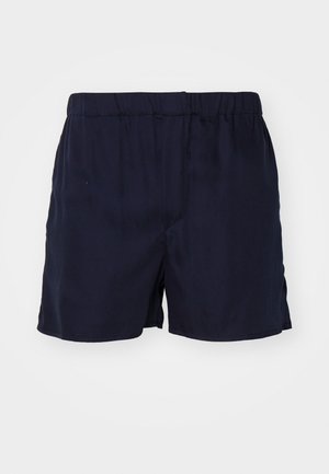Pantaloni corti blu navy realizzati in un tessuto morbido con vita elastica. Presentano un design semplice e una texture liscia, senza motivi o accenti visibili.