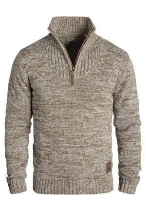 Knit sweater in light brown and cream with a high collar, half-zip, ribbed cuffs and hem, featuring a textured pattern and logo patch.