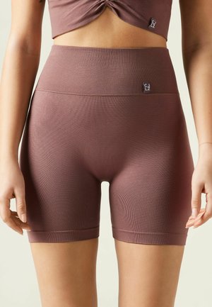 High-waisted, ribbed shorts in mauve. Light texture with a smooth finish. Features a thick waistband and subtle logo detail.