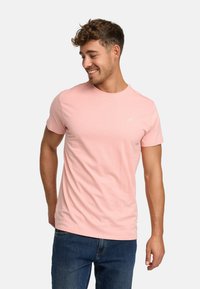 Light pink cotton t-shirt with a round neckline, short sleeves, and a small logo detail on the chest. Casual fit.