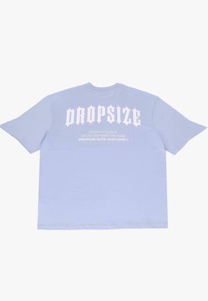 Light blue oversized t-shirt made of cotton. Features bold white text, including "DROPSIZE" and additional text on the back in a stylized font.