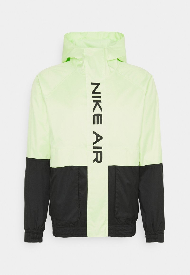 Nike Air -takki neonvihreänä ja mustana. Kevyt materiaali, vetoketjullinen etuosa, pitkät hihat ja logo painettuna pystysuoraan rintaan.