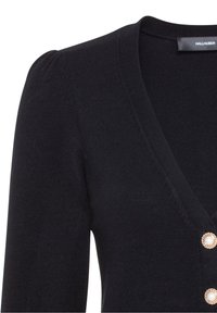 Svart cardigan med V-ringning, ribbad textur och korta puffärmar. Har dekorativa knappar med en pärlliknande mitt.