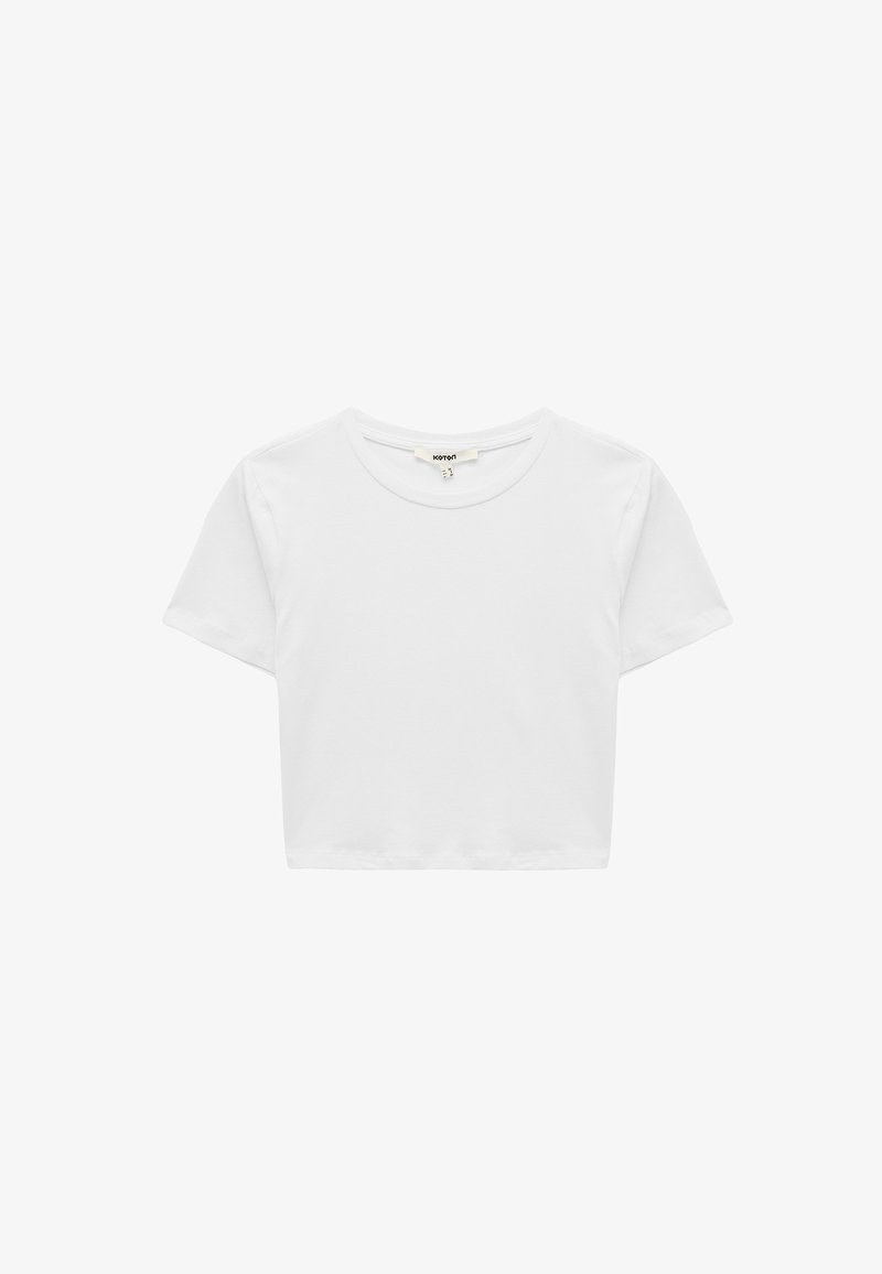 T-shirt bianca cropped realizzata in morbido cotone. Presenta un collo rotondo e maniche corte, con un design semplice e privo di decorazioni.