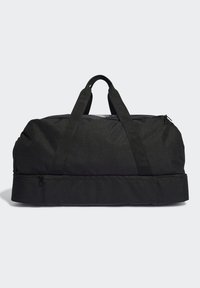 Borsa a duffel nera realizzata in tessuto resistente, dotata di due manici superiori e di un compartimento con zip alla base. Design minimalista, senza loghi visibili.