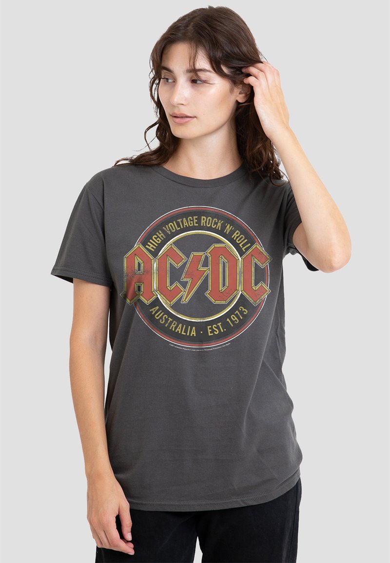 Gray cotton t-shirt featuring a circular AC/DC graphic in red, yellow, and black. Crew neck, relaxed fit, short sleeves.