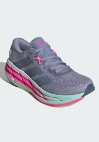 Purple athletic shoe with mesh upper, pink accents, and multicolored sole. Features three dark stripes and a textured pattern throughout.