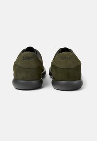 Green suede shoes with a smooth, rounded design. Features a black rubber sole and the brand name "Camper" embossed on the heel.