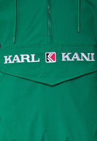 Karl Kani Vindjacka - turquoise