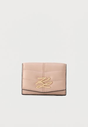 Small beige leather wallet with quilted stitching and a gold intertwined "K" logo on the front flap against a plain background.