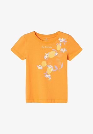 Camiseta de algodón naranja de manga corta, que presenta un diseño gráfico de frutas y flores en blanco y morado claro, con el texto "day dreaming" arriba.