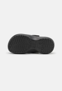 Semelle de chaussure en caoutchouc noir avec une texture antidérapante. Comprend des rainures et des motifs de bande de roulement pour une meilleure traction. Pas de marquage visible ou de détails supplémentaires.