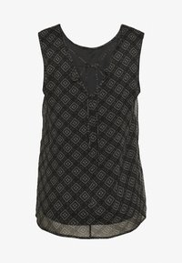 Černý bezrukávový top s geometrickým vzorem v béžové a bílé barvě, s výstřihem do V a detailem na zavazování v přední části.