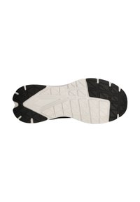 Svart och vit sula av en sportskor med texturerade greppmönster, en krökt form och en framträdande, segmenterad mönstring för bra grepp.