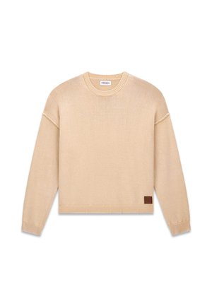 Beiger, gestrickter Pullover mit Rundhalsausschnitt, überschnittenen Schultern und gerippten Bündchen. Verfügt über ein kleines Lederetikett am linken Saum.