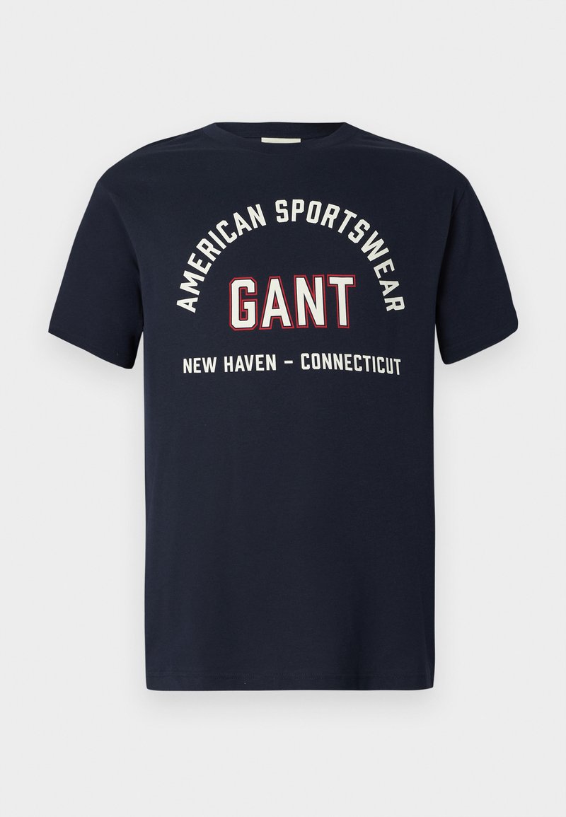 Granatowa koszulka z białym i czerwonym napisem "American Sportswear GANT New Haven - Connecticut" na przodzie.