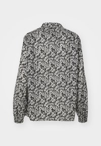 Camicia a maniche lunghe con motivo floreale in bianco e nero, caratterizzata da un colletto e una vestibilità comoda. Tessuto leggero e liscio con polsini a manica arricciati.
