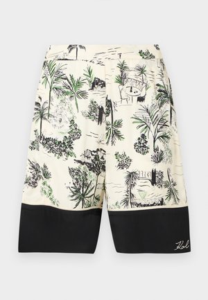 Kratke kopalne hlače iz tkanine s kremasto osnovo, z črnim robom na spodnjem delu in podrobno zeleno-črnim tropskim vzorcem.