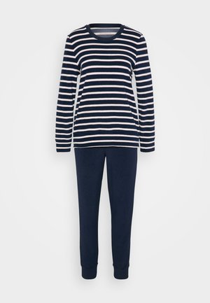 Μπλούζα μακρυμάνικη με ναυτικό και λευκό ρίγες, με στρογγυλή λαιμόκοψη, σε συνδυασμό με απλές ναυτικές παντελόνες. Μαλακό ύφασμα με ελαστικά μανίκια στον αστράγαλο.