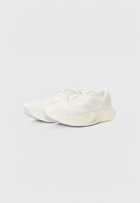 White running shoes with a breathable fabric upper, light gray accents, and a cushioned sole for enhanced comfort.